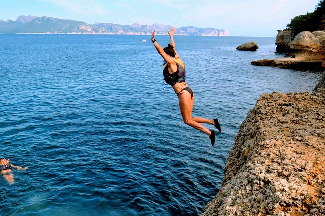 Mallorca: Kayaking, Sea Cave, Cliff Jumping & Snorkel Tour - Sea cave exploring: helmets on, lights ready, and curiosity rewarded