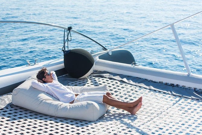Palma Bay Catamaran Half-Day Cruise - Comfort on a shared catamaran: seating, sunbeds, and music